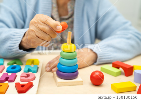Alzheimer disease AD, Asian elderly woman patient suffering from dementia learn practical motor skills rehabilitation. 130130150