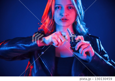 Holding grenade. Cool young woman portrait in neon colors Holding grenade. Cool young woman portrait in neon colors 130130459