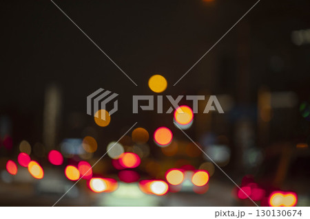 blurred red and yellow car lights in night city traffic, abstract urban bokeh with soft glow, vibrant contrast, transportation service, city night, creative advertising background 130130674
