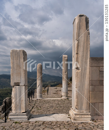 Ancient Trajaneum temple ruins at Pergamon Acropolis, Bergama, Turkey, under a cloudy sky Ancient Trajaneum temple ruins at Pergamon Acropolis, Bergama, Turkey, under a cloudy sky 130131285