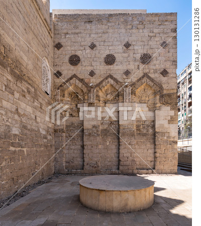 Mosque of al-Zahir Baybars exterior, Cairo, Egypt. Historic stone wall with intricate Islamic architectural details 130131286