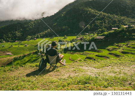ecology travel with man solo travel and camping outdoor relax in rice field at chiangmai thailand in raining season 130131443