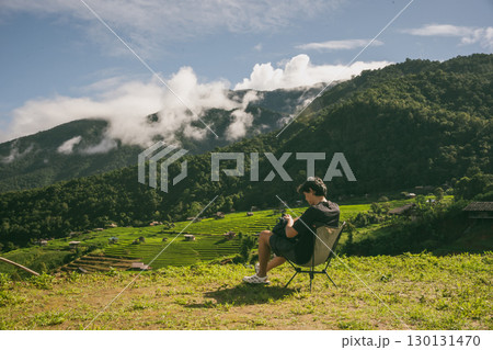 ecology travel with man solo travel and camping outdoor relax in rice field at chiangmai thailand in raining season ecology travel with man solo travel and camping outdoor relax in rice field at chiangmai thailand in raining season 130131470