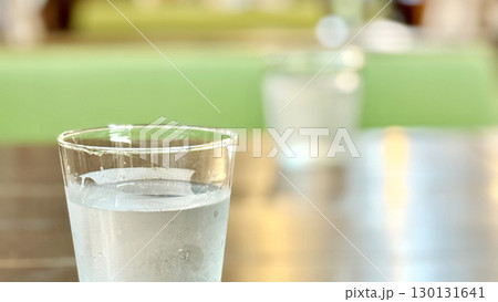 テーブルに向かい合わせで置いた2つの水の入ったコップ 130131641