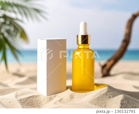 A dropper bottle and packaging box on beach sand background 130132791