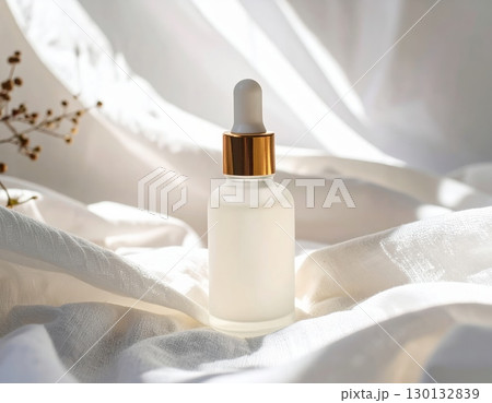 Amber dropper bottle on white cotton Amber dropper bottle on white cotton 130132839
