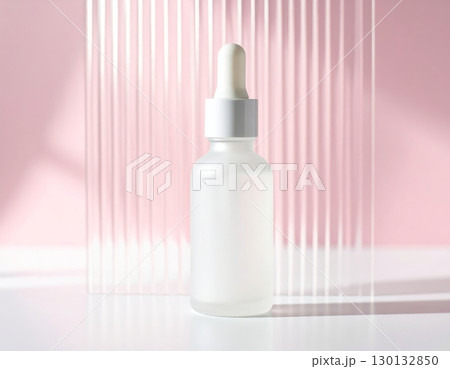Glass dropper bottle with wavy glass on pink background 130132850