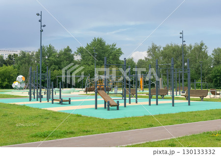 sports ground and playground for children in the city park on a sunny summer day sports ground and playground for children in the city park on a sunny summer day 130133332