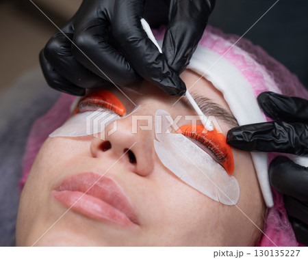Caucasian woman undergoing eyelash lamination procedure.  130135227