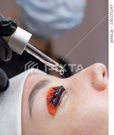The process of professional lamination and tinting of eyelashes in the salon. The process of professional lamination and tinting of eyelashes in the salon. 130135247