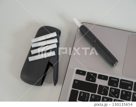 Tobacco heating system next to a laptop.  130135654