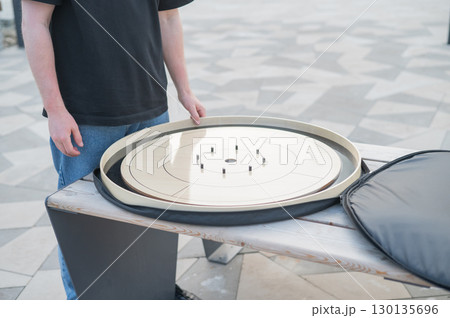 Strategic Game Pieces on a Wooden Board crokinole.  130135696