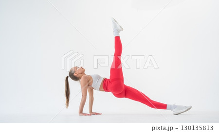 Caucasian woman doing sports exercises on white background.  130135813