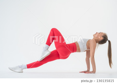 Caucasian woman doing sports exercises on white background. Caucasian woman doing sports exercises on white background. 130135815