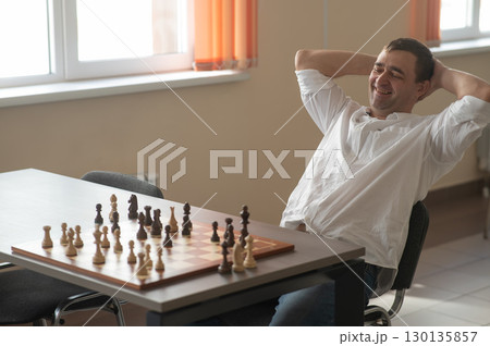 Caucasian man thinking about a chess move.  130135857