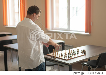 Caucasian man thinking about a chess move.  130135861