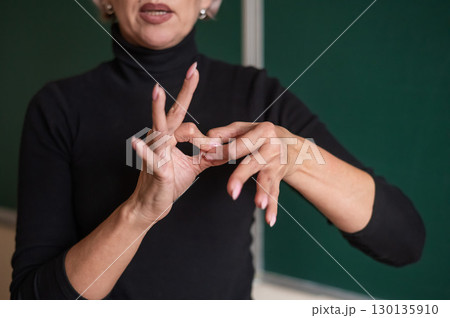 Woman showing the word connection in Russian sign language.  130135910