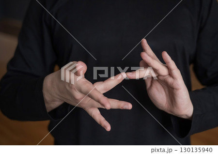 A man shows the word internet in Russian sign language. A man shows the word internet in Russian sign language. 130135940