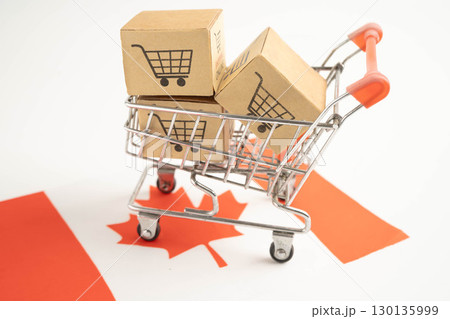Canada shopping, Shopping cart box on Canada flag, import export, finance commerce. Canada shopping, Shopping cart box on Canada flag, import export, finance commerce. 130135999