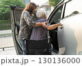Caregiver help Asian elderly woman disability patient get in her car. 130136000