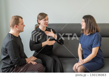 A man and two women are talking in Russian sign language. A man and two women are talking in Russian sign language. 130136063