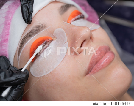 Caucasian woman undergoing eyelash lamination procedure. Caucasian woman undergoing eyelash lamination procedure. 130136418