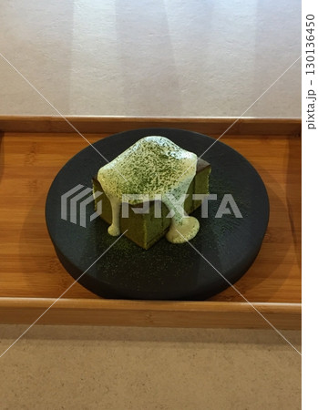 Rich and creamy matcha cheesecake slice with a smooth texture and a hint of earthy green tea flavor. Perfect for dessert lovers seeking a balance of sweetness and bitterness in every bite! 130136450