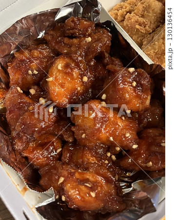 Crispy Korean fried chicken, perfectly glazed with a sweet and spicy sauce. Ideal for food photography and menus, showcasing the irresistible crunch and flavor of this beloved dish. Crispy Korean fried chicken, perfectly glazed with a sweet and spicy sauce. Ideal for food photography and menus, showcasing the irresistible crunch and flavor of this beloved dish. 130136454