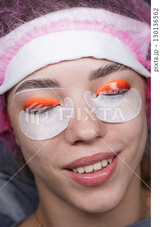 Caucasian woman undergoing eyelash lamination procedure. top view. Caucasian woman undergoing eyelash lamination procedure. top view. 130136562