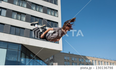 A girl jumps on an outdoor trampoline. A girl jumps on an outdoor trampoline. 130136798