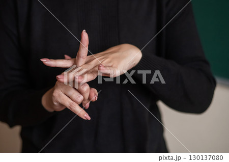A woman shows the word integration in Russian sign language. A woman shows the word integration in Russian sign language. 130137080