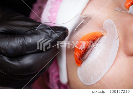 Caucasian woman undergoing eyelash lamination procedure.  130137239