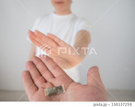 The woman refuses to take chewing tobacco.  130137259