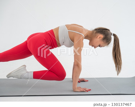 Young woman doing plank exercise on white background. Young woman doing plank exercise on white background. 130137467