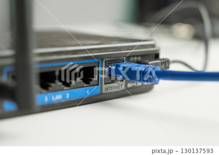 The internet cable is plugged into the router. The internet cable is plugged into the router. 130137593