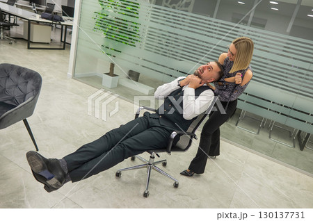 Colleagues fooling around at work in the office.  130137731