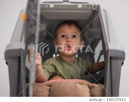 A small child in a closed cage. 130137813