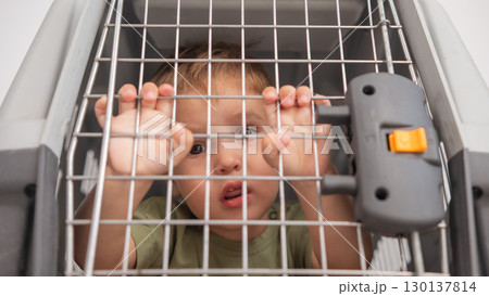 A small child in a closed cage. 130137814