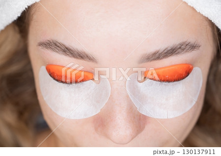 Caucasian woman undergoing eyelash lamination procedure. top view.  130137911