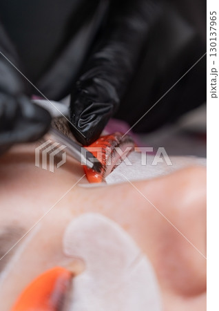 The process of professional lamination and tinting of eyelashes in the salon. The process of professional lamination and tinting of eyelashes in the salon. 130137965