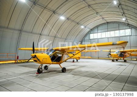 Yellow airplane glider in the hangar. Yellow airplane glider in the hangar. 130137998