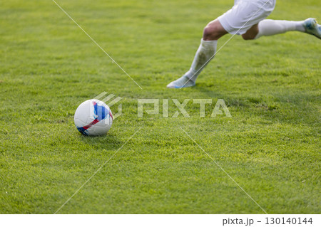 Athletes with a ball play football on the grass Athletes with a ball play football on the grass 130140144