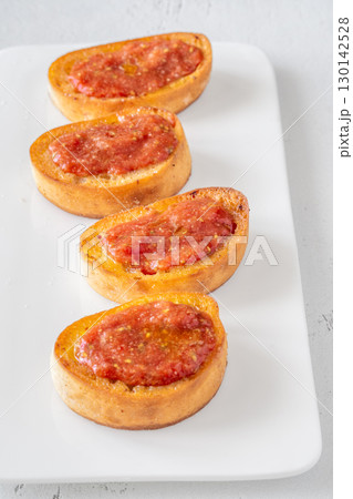 Traditional Pan con Tomate Sandwiches Served on White Plate with Rustic Style 130142528