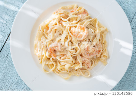 Creamy fettuccine shrimp pasta white plate savory sauce gourmet flavor Creamy fettuccine shrimp pasta white plate savory sauce gourmet flavor 130142586