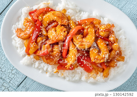 Sweet sour prawns with pineapple bell peppers onions served with rice Sweet sour prawns with pineapple bell peppers onions served with rice 130142592