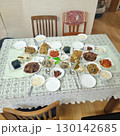 The images show a large and complete Korean home-cooked meal, known as a 'hansang,' with a variety of traditional side dishes, including rice, kimchi, japchae, and various jeon. 130142685
