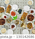 The images show a large and complete Korean home-cooked meal, known as a 'hansang,' with a variety of traditional side dishes, including rice, kimchi, japchae, and various jeon. 130142686