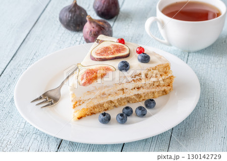 Cake wedge topped berries figs served tea cup rustic cozy setting 130142729