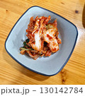 The images show a small bowl of kimchi, a classic Korean side dish of fermented and spiced napa cabbage. 130142784