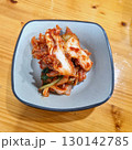 The images show a small bowl of kimchi, a classic Korean side dish of fermented and spiced napa cabbage. 130142785
